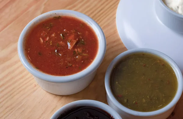 Satsebeli, tkemali ve narsharap, Gürcistan 'ın ahşap mutfak soslarının yakın plan çekimleri.. 