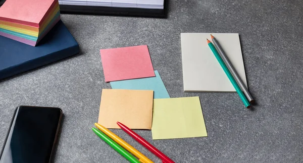 paper and pencils with pens on the desktop.Stationery on  desktop with phone