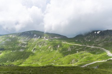 Bulutlu ve mavi gökyüzü olan dağ manzarası