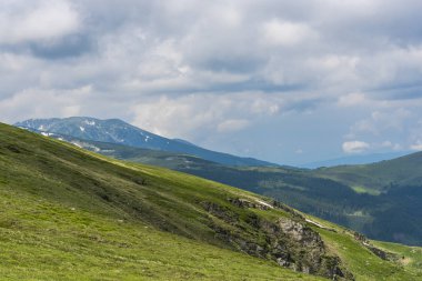 Bulutlu ve mavi gökyüzü olan dağ manzarası