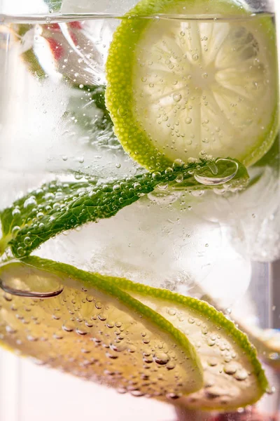 Gin tonic with lime, ice and red fruit — Stock Photo, Image