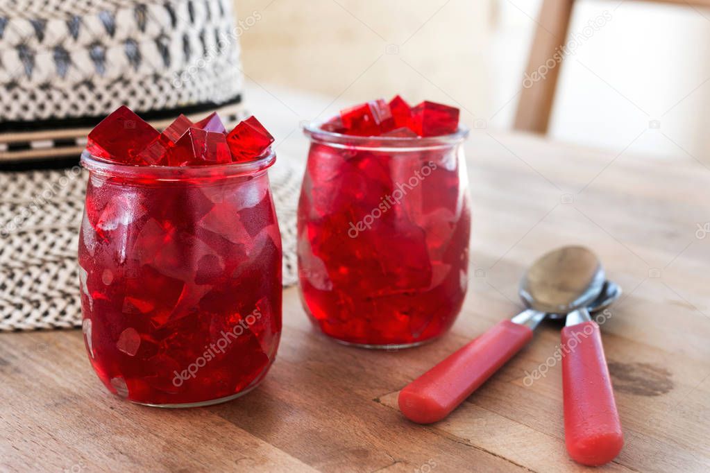 red jelly, cut into dice, inside two glasses of glass