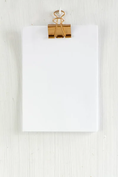 empty clipboard on white wooden background