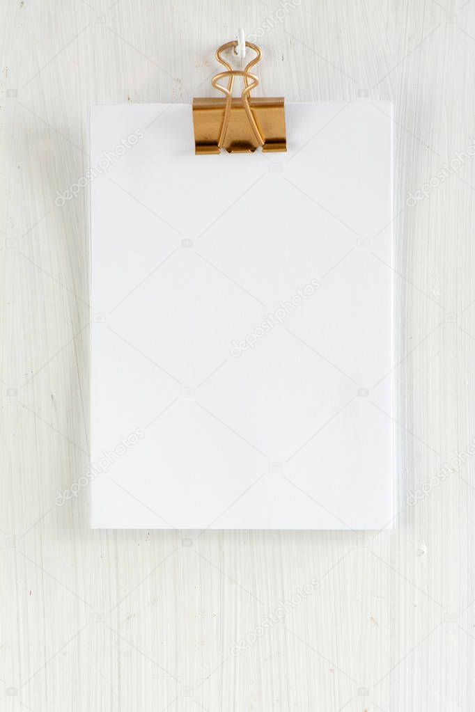 empty clipboard on white wooden background 