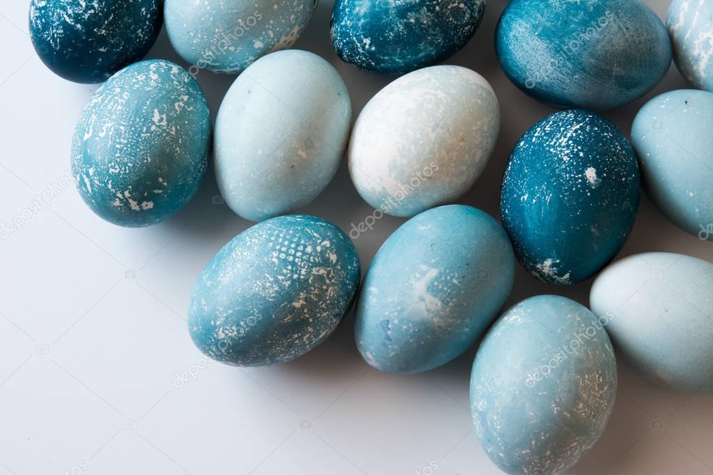 easter eggs, dyed blue dye on white surface