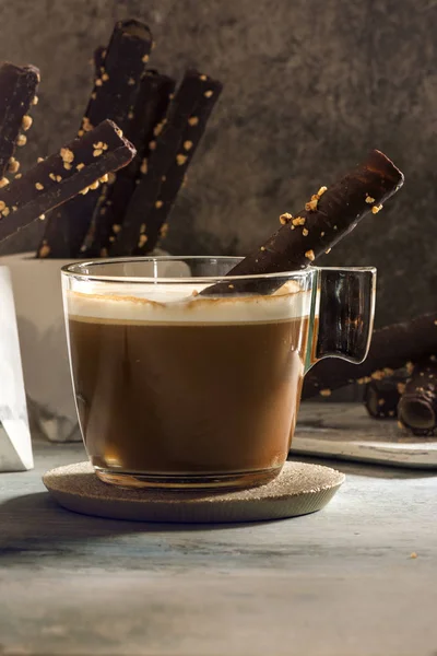 Cappuccino and wafer Chocolate Rolls with almonds, on stone dish — Stock Photo, Image