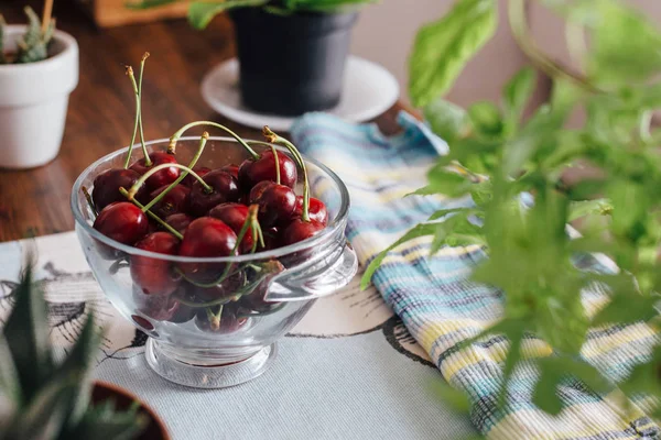 Ecological cherries in glass bowl, on the table — Stock Photo, Image