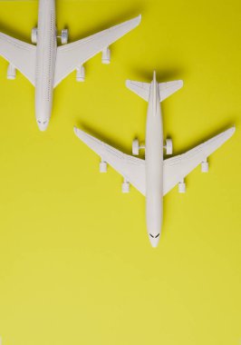 Two jet airplane on yellow background. Travel around the world.