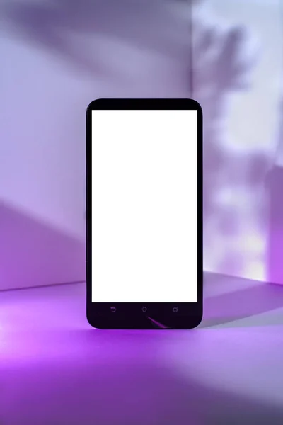 Minimalist modern smartphone mockup for presentation, in perspective front of the corner angle of the wall, with purple abstract and plant shapes on background. application display, information or graphics