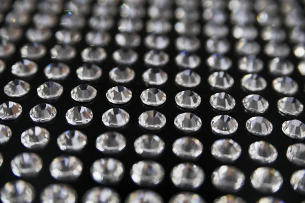 Diamonds glued on a black surface — Stock Photo, Image