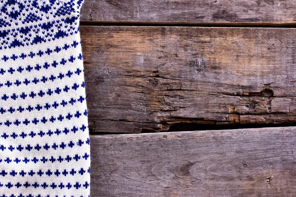 knitted plaid, sweater on old wooden boards