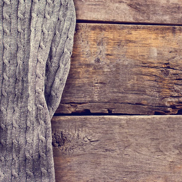 knitted plaid, sweater on old wooden boards