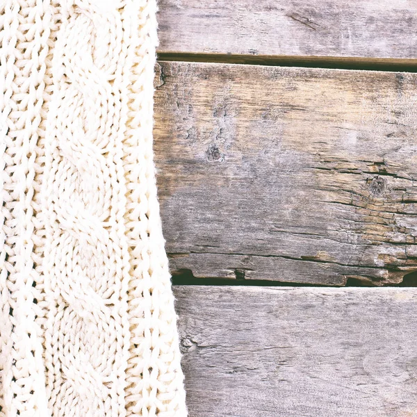 knitted plaid, sweater on old wooden boards