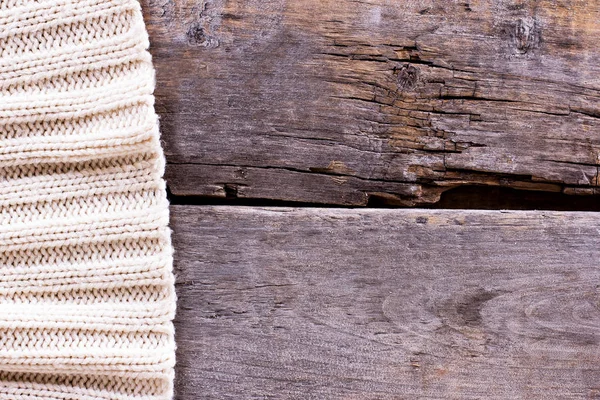 knitted plaid, sweater on old wooden boards