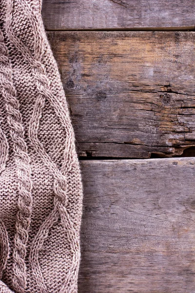 knitted plaid, sweater on old wooden boards