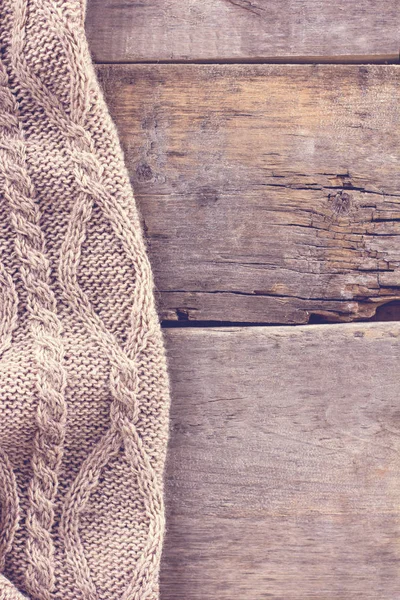 Knitted plaid, sweater on old wooden boards — Stock Photo, Image