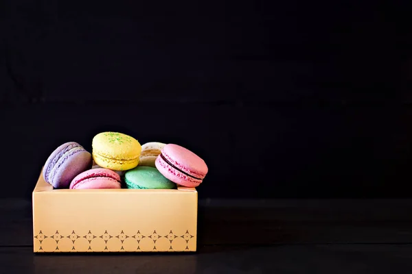 Multicolored macaroons a black — Stock Photo, Image