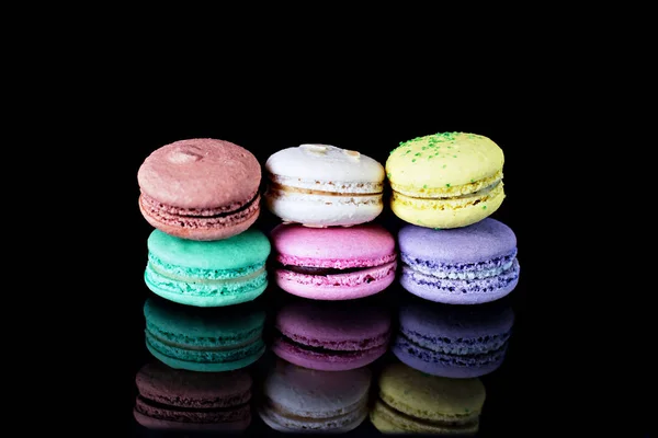 Multicolored macaroons a black — Stock Photo, Image