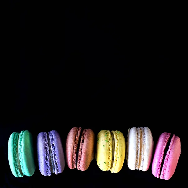 Multicolored macaroons  a black background. — Stock Photo, Image