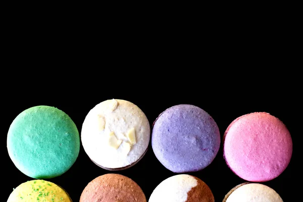 Multicolored macaroons  a black background. — Stock Photo, Image