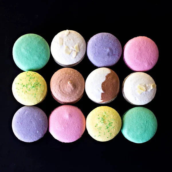 Multicolored macaroons   a black background. — Stock Photo, Image