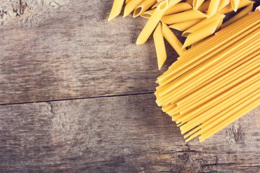 Makarna, makarna, spagetti ahşap arka plan üzerinde.