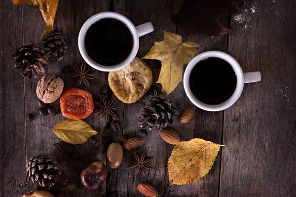 A cup of coffee with espresso and autumn leaves.