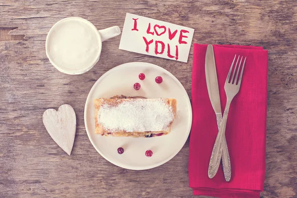 strudel and Valentine\'s Days decor. Strudel (pie) with  cranberries and powdered sugar with Valentine\'s Days decor. Rustic style. valentine, gift on Valentine\'s Day, Mothers Day, gift, surprise, heart