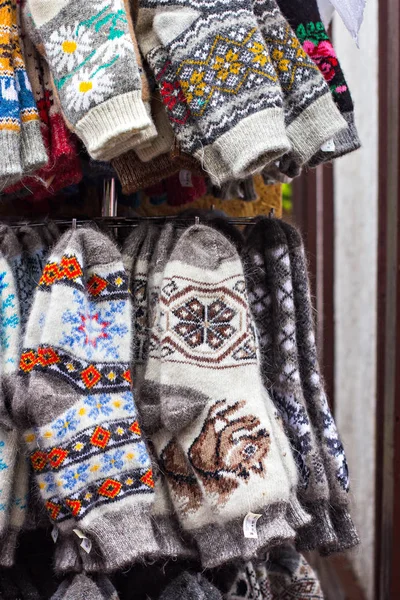 Gestrickte Handschuhe und Socken mit bunten Ornamenten zum Verkauf auf dem Markt — Stockfoto