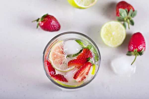 Lemonade with strawberries and lime.