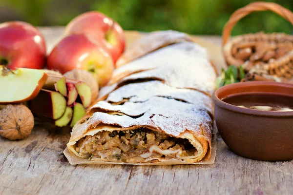 Strudel with apples. Summer breakfast in nature.