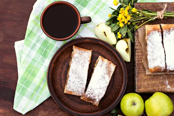 Strudel with apples. Summer breakfast in nature.