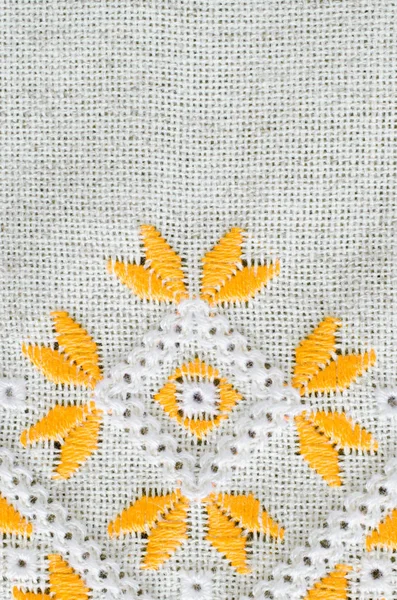 Embroidery by yellow cotton threads on flax.