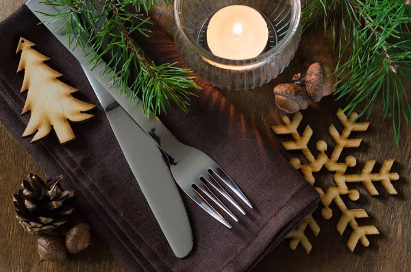 Rustic Christmas table setting with candle.