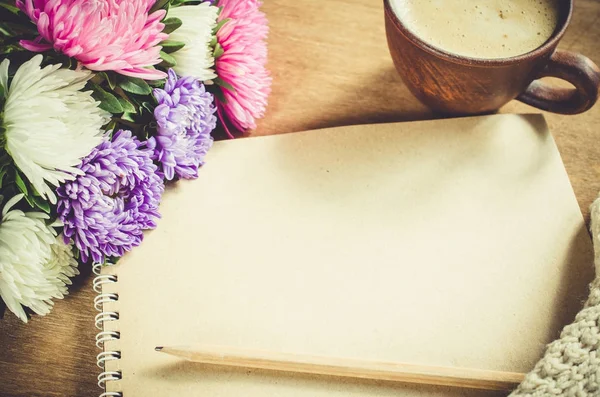 Boş kahverengi defter ile sonbahar çiçekler.