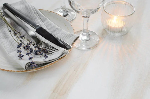 Festive table setting with candles and lavender.