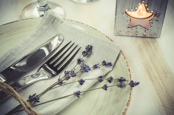 Festive table setting with candles and lavender. — Stock Photo, Image