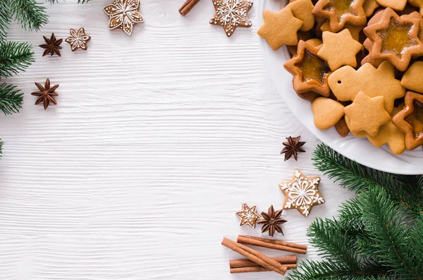 Yeni pişmiş Noel kurabiyesi, baharat ve köknar dallarıyla mutfak arka planı. Boşluğu kopyala