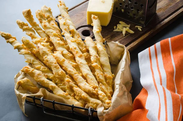 Cheese stick. Breadsticks with cheese on dark background. Concept for snack or party time