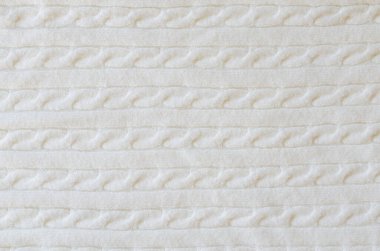 Bej örülmüş yün arka plan. Örgü kumaş dokusu. Kopya alanı ve üst görünümü olan İskandinav minimalizmi