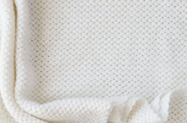 Bej örülmüş yün arka plan. Örgü kumaş dokusu. Kopya alanı ve üst görünümü olan İskandinav minimalizmi