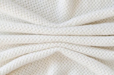 Bej örülmüş yün arka plan. Örgü kumaş dokusu. Kopya alanı ve üst görünümü olan İskandinav minimalizmi