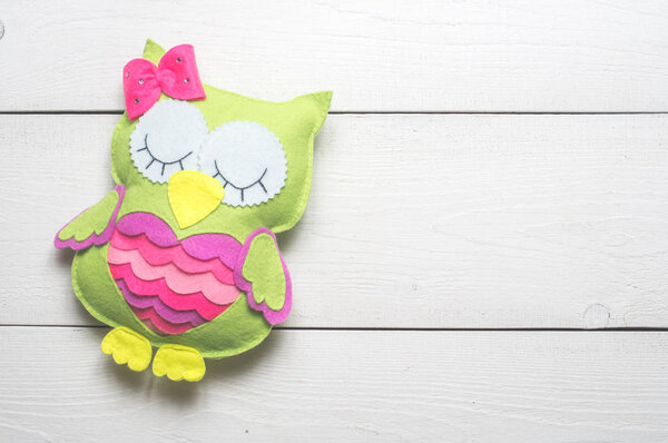 Green owl of colored felt 