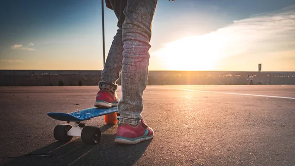 Close-up van de voeten op het skateboard op de stoep — Stockfoto