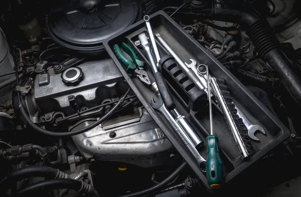 Tools of auto mechanic with engine — Stock Photo, Image