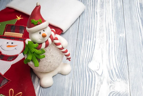 Happy snowman with red sock — Stock Photo, Image