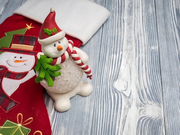 Happy snowman with red sock — Stock Photo, Image