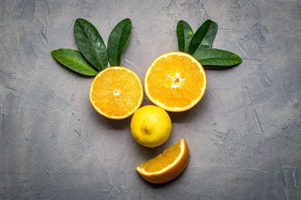 creative collage: a smiling face made of oranges and lemon