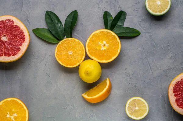 creative collage: a smiling face made of oranges and lemon