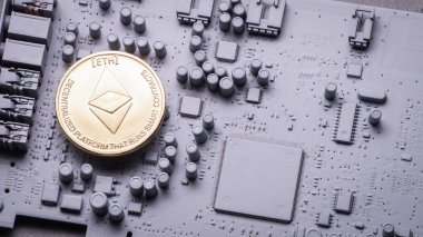 Perspektif Kripto-para: birkaç altın kaplama Ethercoins gri renk baskılı devre kartı üzerindeki.